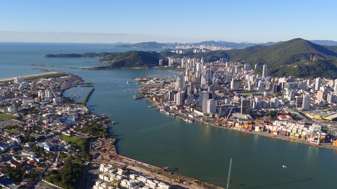 Aerial panorama of coastal Itajaí city skyline with bay and intake water channel, Santa Catarina, Brazil