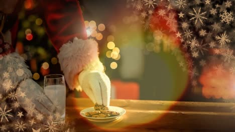 Santa-eating-cookies-and-milk-at-Christmas-home-and-glowing-warmth