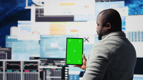 entrepreneur looks at tablet with chroma key for analysis