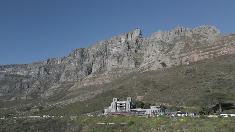 drone shot of table mountain looming over the cape town visitor center.
