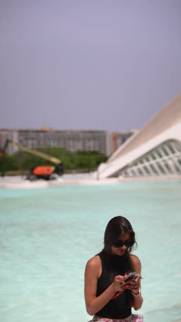 woman using phone in city park