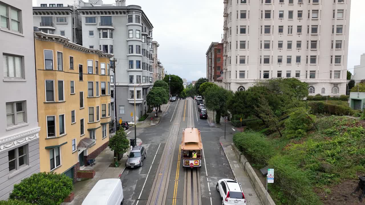 Aerial following a streetcar driving up Hyde Street in San Francisco neighborhood