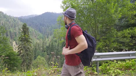 Tourist-walking-on-the-road-in-the-forest.