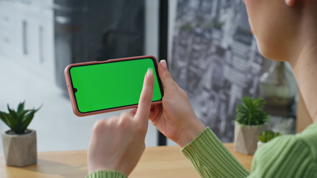 Employee finger tapping mockup cellphone at workplace closeup. Woman surfing web