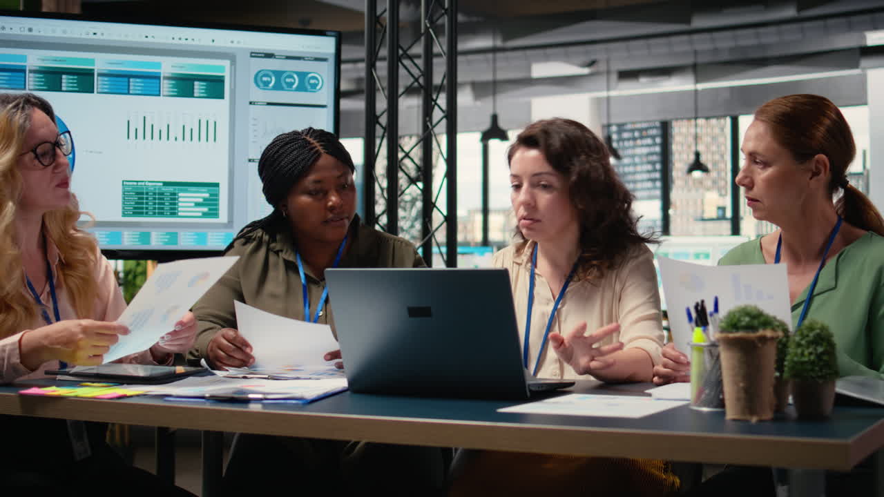 Vertical Video Empowered businesswomen evaluating graphs and strategy reports