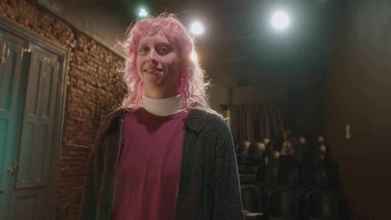 Young Actress with Pink Hair Posing on Theater Stage