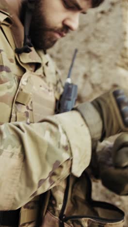 hands of a soldier putting on gloves before battle