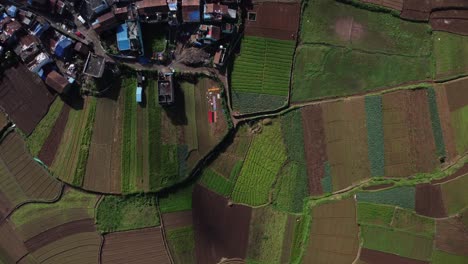 overhead drone shot of poombarai village on palani hills among terrace farming fields, scenic farmland, tamil nadu, india