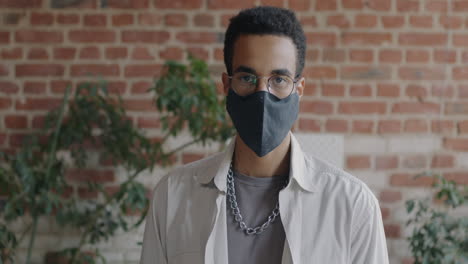 young man wearing face mask in urban setting