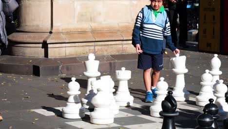 people enjoying giant chess game outdoors