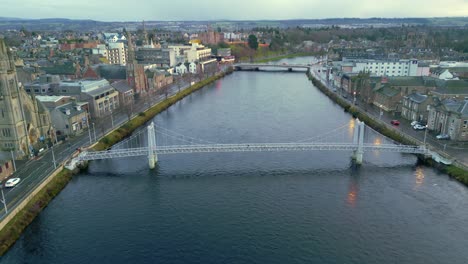 flying above the ness river towards the greig street bridge as pedestrians cross