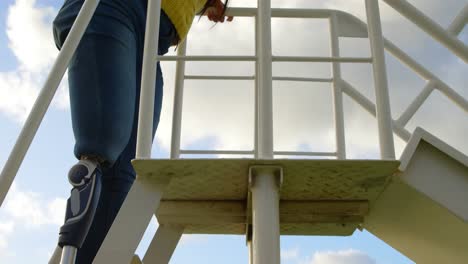 Low-angle-view-of-disabled-woman-climbing-ladder-in-the-park-4k