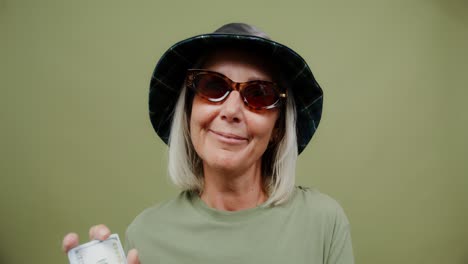 stylish senior woman holding money