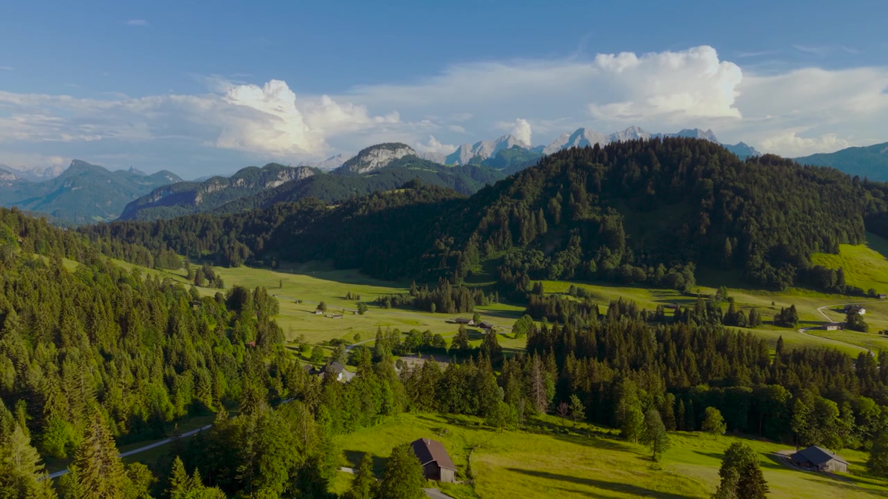 Vista panoramica di verdi campi alpini, foresta e cime montuose nella valle di Unken Heutal. Veduta aerea Austria.