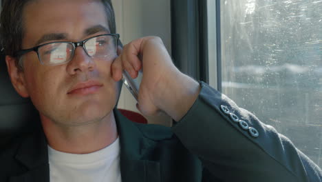 Man-chatting-on-the-cell-during-train-ride