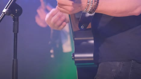 close up of female hands playing acoustic guitar, musician practicing and learning new chords and melodies, music performer preparing for a concert or recording session