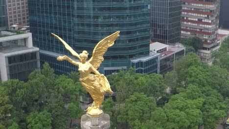 drone flying close to angel of independence monument in mexico