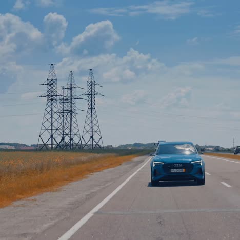 rear view of audi e-tron. blue audi suv car driving on the motorway