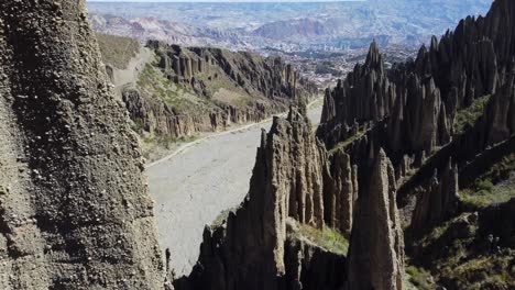 Aerial-flies-past-steep,-sharp-conglomerate-rock-spire-formations,-BOL