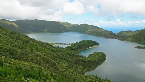 vista panorámica de la lagoa do fogo en las azores con colinas verdes exuberantes y un lago tranquilo