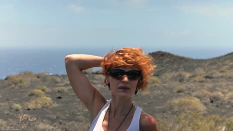 a close up shot around a redhead woman in a volcanic island