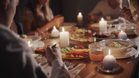 happy family has a festive dinner in honor of thanksgiving, they sit at the festive table with delicious food