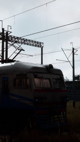 a rusty train sitting on a railway track