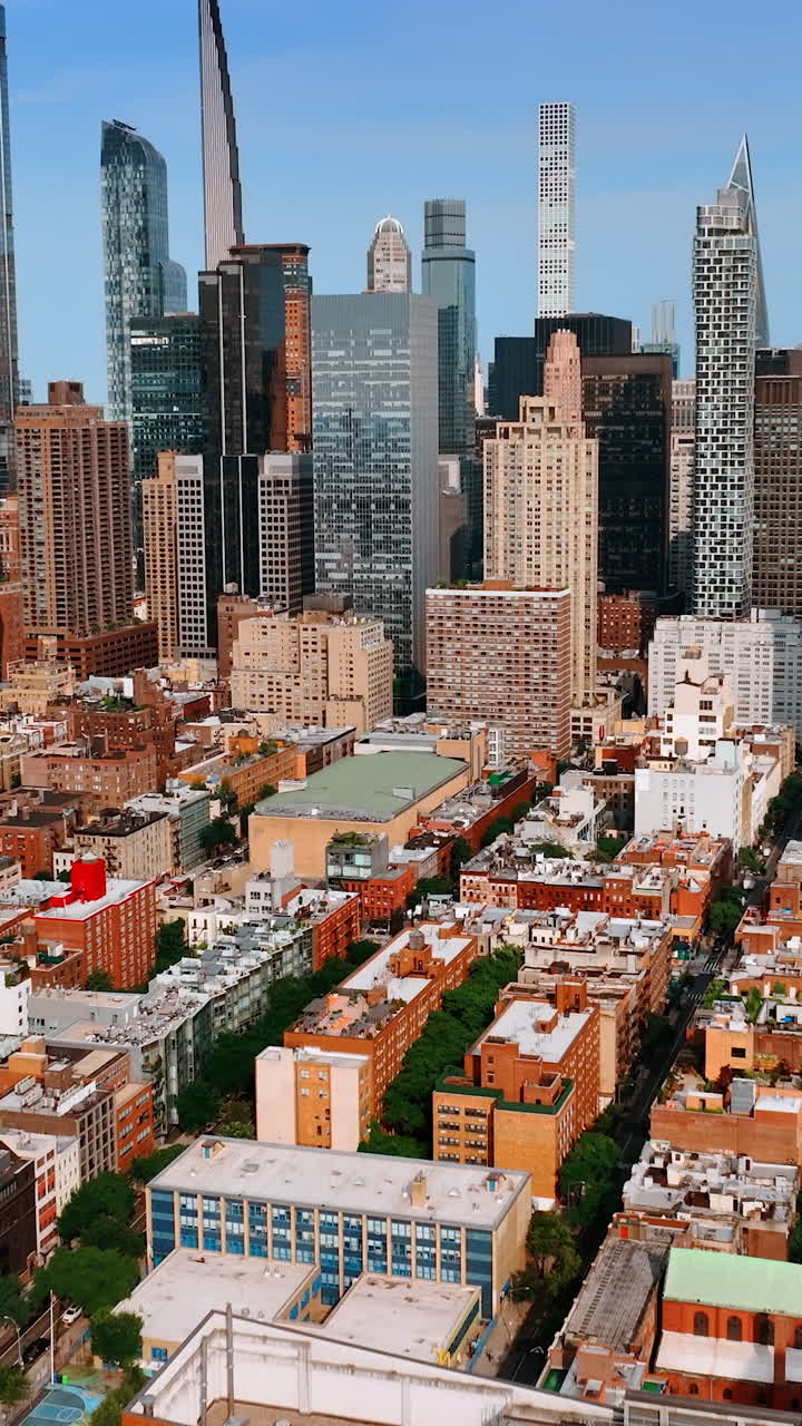 Sunny cityscape of New York from aerial view. Drone footage approaching stunning skyscrapers. Vertical video