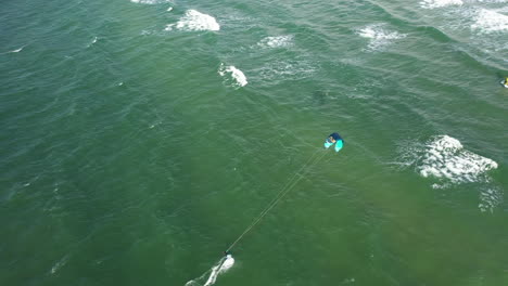 AERIAL:-Follow-Shot-of-Isolated-Surfer-in-Green-Baltic-Sea-on-Perfect-Sunny-Weather