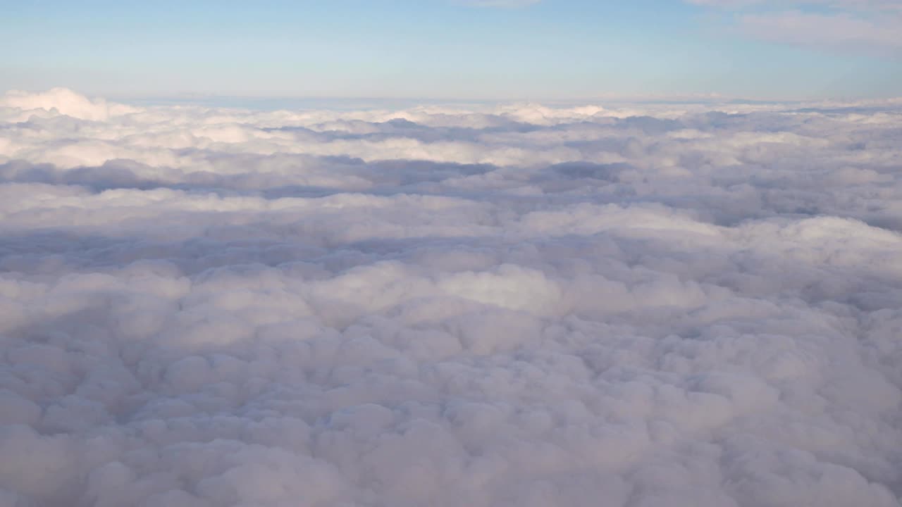 Beautiful Aerial View Of Clear Sky Over White Fluffy Clouds From Height Flight Of Plane