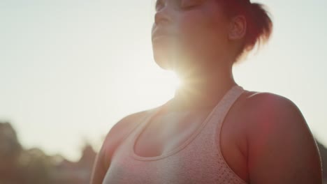 Woman-practicing-breathing-exercise-at-the-park-in-summer-day