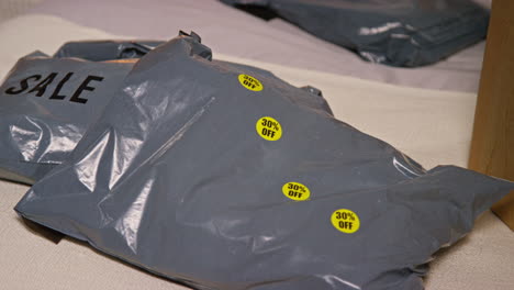 sale items in plastic bags with 30% off stickers