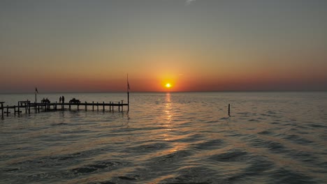 Aerial-pan-view-of-sunset-over-Mobile-Bay,-Alabama