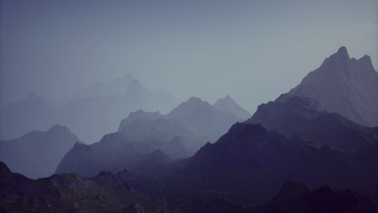 Mountain range fading into twilight with layered peaks and soft hues