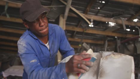 african man sanding a car