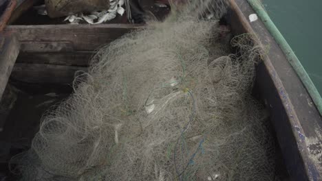 Traditional-Fishermen-Reeling-in-Nets-with-Small-Catches,-Portrait-of-Traditiona-Fishermen-pull-in-nets,-Finding-Just-a-Few-Fish-from-His-Fishing-Nets