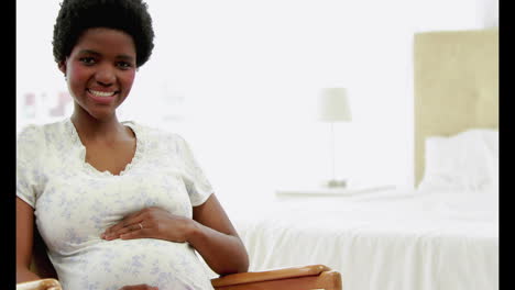 Pretty-pregnant-woman-smiling-at-camera