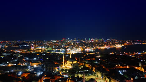 night cityscape of the beautifully lit city with a mosque in the center. footage over kemer, turkey with stunning illumination