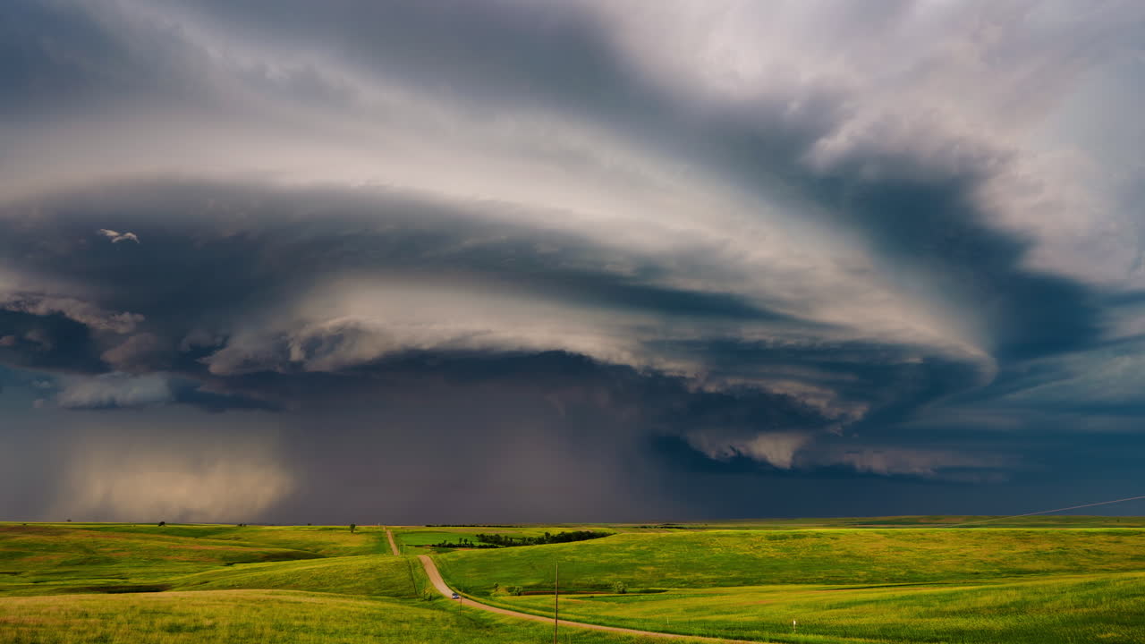 Dramatic Supercell Storm over Green Prairie Landscape