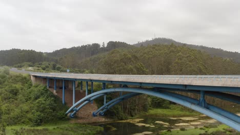 cinematic rising aerial from below bridge, revealing spanish highway