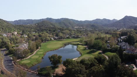 aerial descending panning shot of a golf course at a luxury country club in lake sherwood, california. 4k at 30 fps