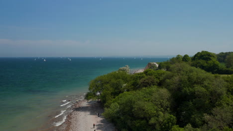 Scenic-aerial-view-of-Brodten,-coastline-shoreline-in-Germany,-drone-flying-forward,-day