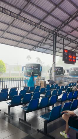 rainy day at the bus station: waiting for the pattaya or bangkok bus
