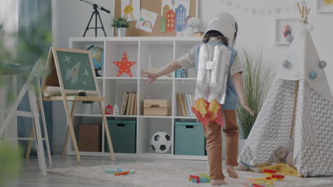 child playing as an astronaut in a playroom