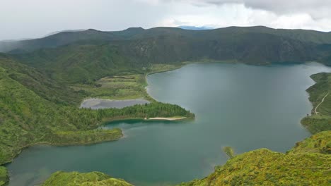 Scenic-view-of-Lagoa-do-Fogo-with-lush-green-hills-and-calm-waters-in-the-Azores