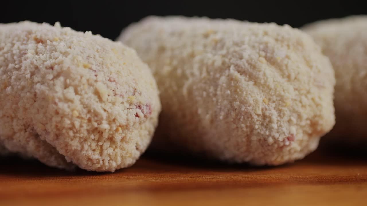 Portuguese croquettes on wooden desk close-up macro. Breaded croquette of fish, potatoes and ham. Man cooking spanish food. . High quality 4k footage