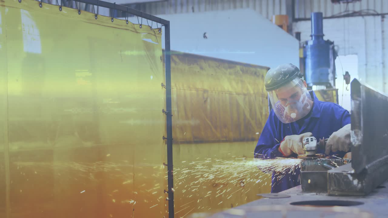Fabricator pressing grinder on clamped part in metal shop, finishing edges, producing sparks
