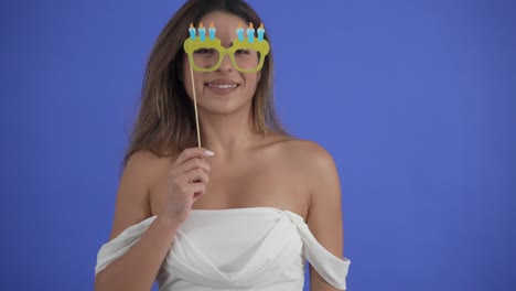 close-up of a pretty young woman posing with silly party favors