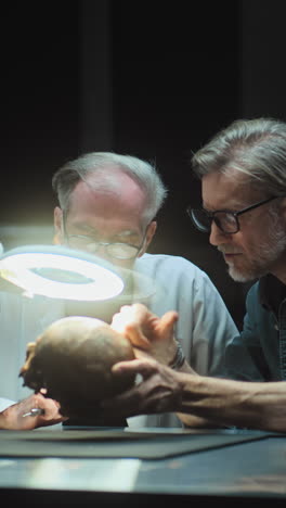 scientists examine human remains and 3d models in a laboratory setting