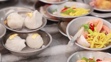 a vibrant display of dim sum dishes in a bustling phuket market, showcasing colorful ingredients and traditional presentation